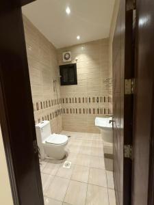 a bathroom with a toilet and a sink at Marina Jada hotel in Jeddah