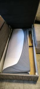 a mattress in a box on the floor at Masčio apartamentai in Telšiai