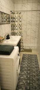 a white bathroom with a sink and a shower at Masčio apartamentai in Telšiai +23 photos