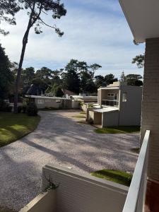 a driveway of a home with a house at Casa en Complejo Sierra Alta in Punta del Este