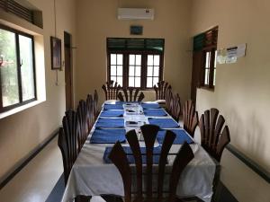 a long dining room with a long table and chairs at Wild Wild Holiday in Kataragama