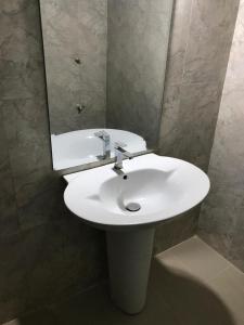 a bathroom with a white sink and a mirror at Wild Wild Holiday in Kataragama +15 photos
