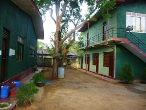 an empty courtyard of a building with a tree at Wild Wild Holiday in Kataragama