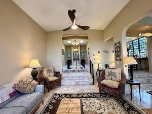 a living room with a couch and a ceiling fan at Vieques BioBay Bed and Breakfast in Vieques +266 photos