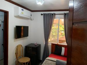 a small bedroom with a bed and a window at Noah Bed&Breakfast 3 Private Room NEWHOME Quiet Place to Stay 14 Minutes to PPS Airport in Puerto Princesa City
