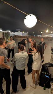a group of people standing around in a room at Bedcoin Hostel in Hurghada +56 photos
