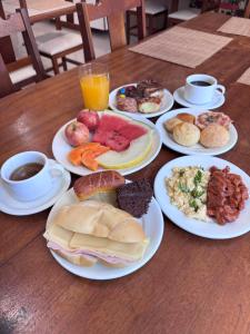 a wooden table with plates of food on it at Hotel Executive Uberaba in Uberaba