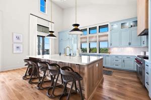a kitchen with blue cabinets and a large island with bar stools at 283 Lakeview Drive in Seagrove Beach