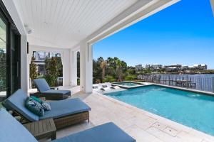 a swimming pool with a patio furniture and a view at 283 Lakeview Drive in Seagrove Beach +76 photos