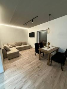 a living room with a couch and a table at Апартаменти Rest Hill in Vorokhta