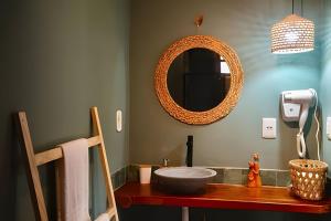 a bathroom with a sink and a mirror at Casa Brisa do Vale - Ar condicionado nos 2/4 .. in Lençóis +13 photos