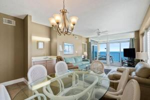 a living room with a glass table and chairs at Jade East Towers 1850 in Destin