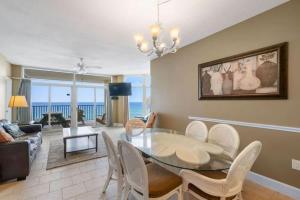 a dining room with a table and chairs and the ocean at Jade East Towers 0740 in Destin
