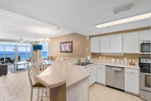 a kitchen and living room with a view of the ocean at Jade East Towers 0740 in Destin