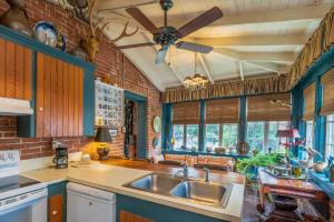a kitchen with a sink and a ceiling fan at Terrace Carriage House in Natchez