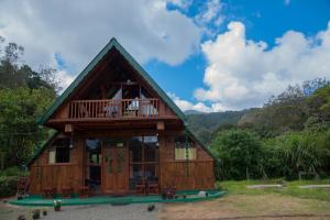 a small house with a balcony on top of it at Cloud Nest Cabana in Ohiya