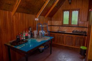 a kitchen with a table with bottles on it at Cloud Nest Cabana in Ohiya