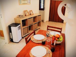 a dining room table with two plates and a bowl of fruit at Eva's Eden in Vourvourou