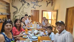 a group of people sitting at a table eating food at La Casa de Isidora in Pan de Azúcar