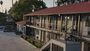a building with a red roof and balconies on it at Jewel City Inn in Glendale
