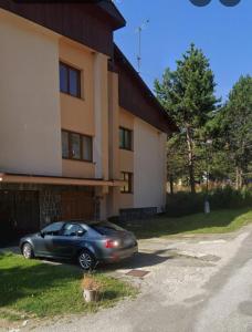 a car parked in front of a house at Apartmán Donovaly 90 in Donovaly