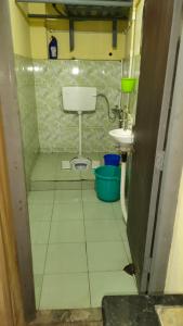 a small bathroom with a toilet and a sink at Hills Vacation Hostel in Darjeeling