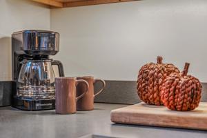 a pineapple sitting on a cutting board next to a coffee maker at Black Forest - Wifi, Pet Friendly, Grill, Deck, Screen Porch, Family Friendly, Fireplace, Pool Access, Hiking in Berkeley Springs