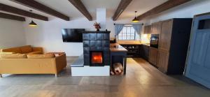 a living room with a fireplace in the middle of a room at Chalupa Louka in Slavonice