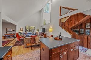 an open kitchen and living room with a staircase at Black Forest - Wifi, Pet Friendly, Grill, Deck, Screen Porch, Family Friendly, Fireplace, Pool Access, Hiking in Berkeley Springs +45 photos