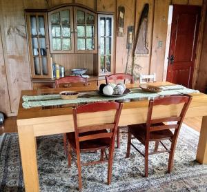 a dining room with a wooden table and chairs at Hostal los arrayanes in Puerto Carmen