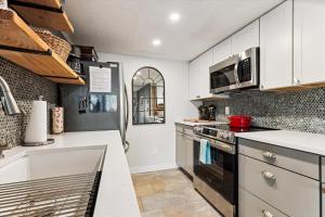 a kitchen with white cabinets and a stove top oven at The Summit at Mountainside in Stowe