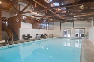 a large swimming pool with blue water in a building at The Summit at Mountainside in Stowe
