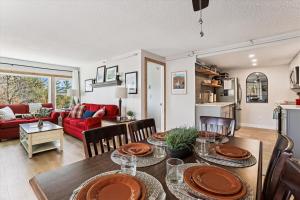 a kitchen and living room with a table and chairs at The Summit at Mountainside in Stowe +24 photos