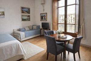 a bedroom with a bed and a table and a couch at Bosa Exclusive Apartments "Bosa Apartments" in Bosa +77 photos