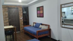 a bedroom with a blue bed and a door and a table at Central Apartment 2 in Ouro Preto