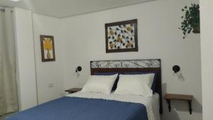 a bedroom with a bed with a blue comforter at Central Apartment 2 in Ouro Preto +5 photos