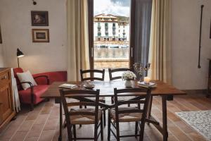 a dining room with a table and chairs and a window at Bosa Exclusive Apartments "Bosa Apartments" in Bosa