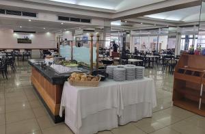 a table with plates of food on it in a restaurant at Topaz Hotel in St. Paul's Bay