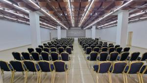 an empty room with chairs and a screen at Topaz Hotel in St. Paul's Bay