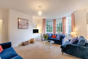 a living room with two blue couches and a table at 2 Bed in Southwell oc-n30605 in Southwell