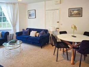 a living room with a blue couch and a table at 2 Bed in Southwell oc-n30605 in Southwell