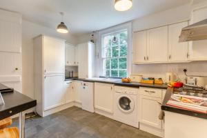 a kitchen with white cabinets and a washing machine at 2 Bed in Southwell oc-n30605 in Southwell +29 photos