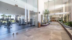 a large lobby with a gym with plants in it at Sonoran Star Signature 3-Bedroom Beachfront Luxury Condominium in Puerto Peñasco