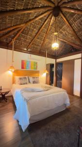 a bedroom with a large bed with a wooden ceiling at Cinque Terre Pousada & Bistrô in Rio de Janeiro