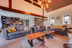a living room with two couches and a table at 4 Bed in Ffestiniog oc-bow172 in Ffestiniog