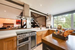 a kitchen with wooden cabinets and a stove top oven at 4 Bed in Ffestiniog oc-bow172 in Ffestiniog