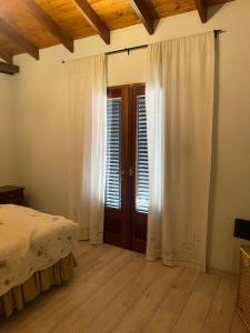 a bedroom with a bed and a wooden floor at Villa Paula in Ranchos