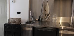 a kitchen with a sink and a counter top at Het Verborgen Jagershuisje in Wedde