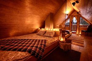 a bedroom with a bed in a wooden cabin at Kakerdaja Private Sauna in Vose