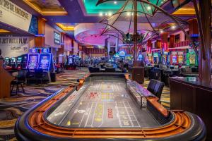 a casino with a poker table and gambling machines at Isle Casino Hotel Waterloo Hotel & Casino - A Caesars Rewards Destination in Waterloo